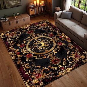 May include: A black area rug with a gold and red floral design. The rug features a central circular pattern with a crescent moon design, surrounded by ornate gold scrollwork and red flowers. The rug has a dark red border.
