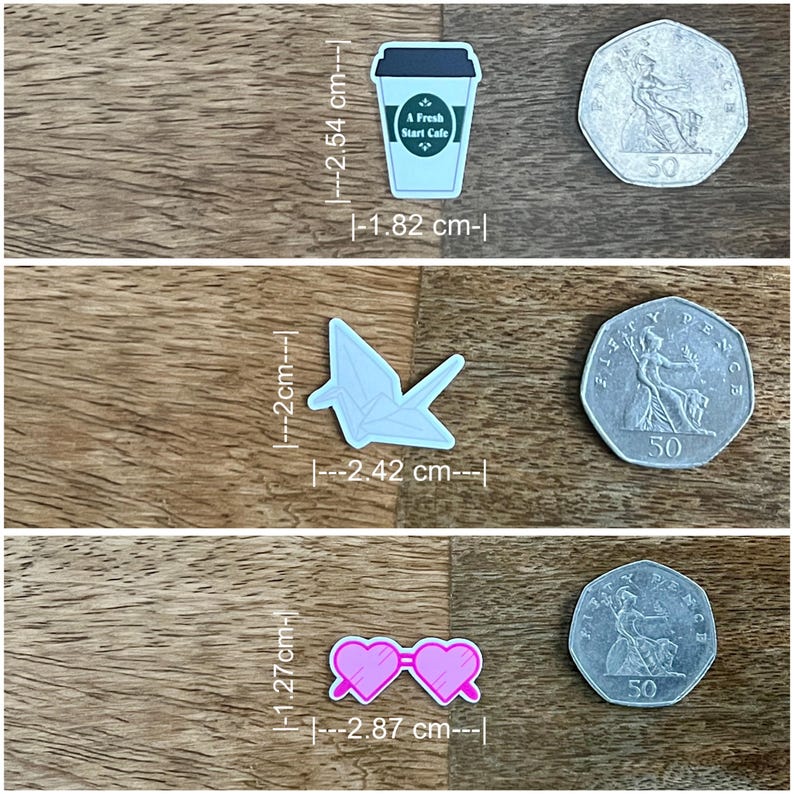 May include: Three decorative charms: a light blue coffee cup with "A Fresh Start Cafe" text (1.82 cm x 2.54 cm), a light blue origami crane (2.42 cm x 2 cm), and pink heart-shaped sunglasses (2.87 cm x 1.27 cm).