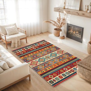 May include: A rectangular rug with a geometric pattern in red, blue, yellow, and cream. The rug has a striped design with repeating diamond and rectangular shapes. The rug is placed on a wooden floor in a living room setting.