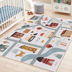 May include: A white children's play rug with a town and road design. The rug features illustrations of houses, vehicles, trees, and a river. The color palette includes shades of brown, yellow, red, and blue.