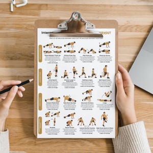 May include: A clipboard displaying a workout routine guide. The guide shows illustrations of exercises like push-ups, lunges, and squats, with set and rep instructions. The clipboard is held by a person. The text includes instructions for sets and reps.