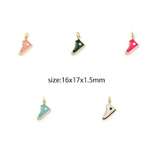 May include: Five gold-colored shoe charms with enamel paint in different colors: pink, green, red, blue, and white. The charms are 1.6 cm x 1.7 cm x 0.15 cm.