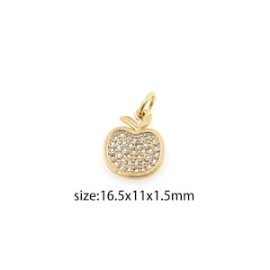 May include: Gold-toned apple charm with clear sparkling stones, size: 16.5x11x1.5mm.