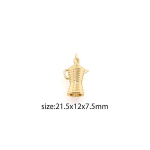 May include: Gold-toned metal charm shaped like a coffee pot with a textured surface. The charm is 21.5 mm x 12 mm x 7.5 mm.