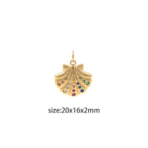 May include: Gold-tone seashell pendant charm with colorful crystal accents. The charm measures 20x16x2mm.