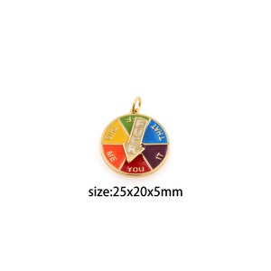 May include: Gold-colored metal charm with a colorful wheel featuring the words "This", "Me", "You", "It", and "That" surrounding the word "F**K". The wheel has a gold arrow pointing to "You". The charm is 2.5 inches in diameter.