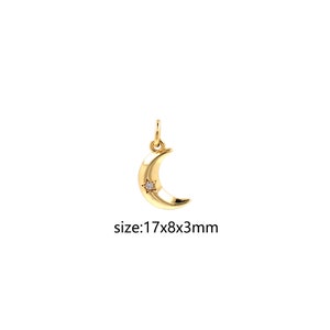 May include: Gold crescent moon charm with a small diamond star in the center. The charm is 17mm x 8mm x 3mm.