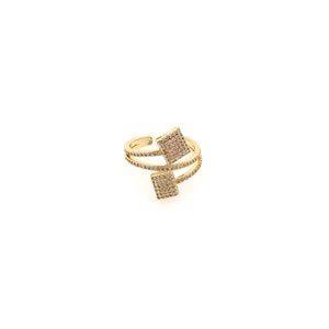 May include: A gold ring with two square-shaped stones set with clear cubic zirconia. The ring is designed with a double band and the stones are set at an angle.