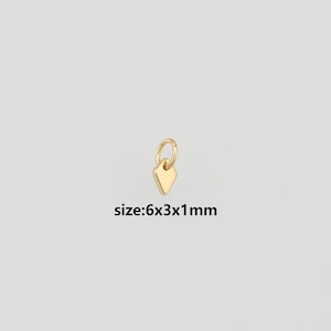 May include: A small gold-colored charm in a diamond shape attached to a circular jump ring. The charm features a smooth, polished surface. The text size:6x3x1mm is printed below the charm, indicating the dimensions in millimeters.