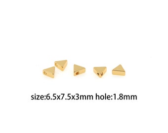 May include: Five gold triangle-shaped metal beads with a hole in the center. The beads measure 6.5x7.5x3mm with a 1.8mm hole. size:6.5x7.5x3mm hole:1.8mm