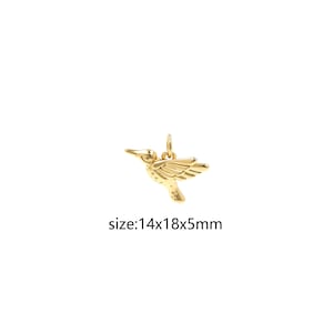 May include: Gold hummingbird charm pendant, measuring 1.4 inches by 1.8 inches by 0.5 inches.