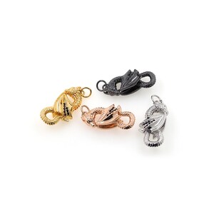 May include: Four dragon-shaped clasps in gold, rose gold, silver, and black.