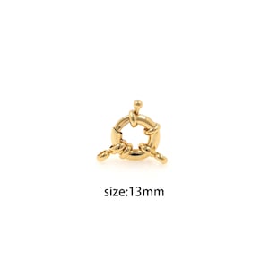 May include: Gold-toned metal clasp with a twisted design. The clasp is 13 mm in diameter.  The clasp is a jewellery finding for making necklaces, bracelets, and other jewellery.