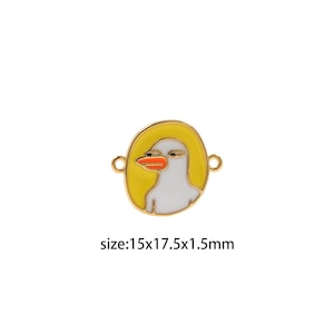 May include: A gold-colored metal charm with a white duck face and orange beak. The duck is surrounded by a yellow circle. The charm is 1.5 cm thick, 1.5 cm wide, and 1.75 cm tall.  size:15x17.5x1.5mm