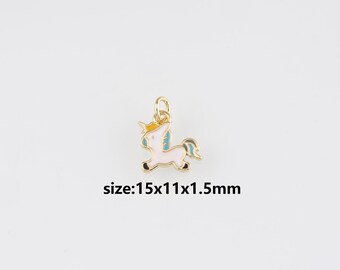 May include: A gold-coloured unicorn charm with white, blue, and yellow enamel details. The charm is approximately 1.5 x 1.1 x 0.15 cm in size. The charm has a loop for attaching to a necklace or bracelet.