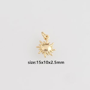 Könnte beinhalten: Ein goldfarbener Sonnenanhänger mit einer Schlaufe zum Befestigen. Die Sonne hat eine strukturierte Oberfläche und spitze Strahlen. Der Text "size:15x10x2.5mm" steht darunter. Maße: 1,5 cm x 1 cm x 0,25 cm.