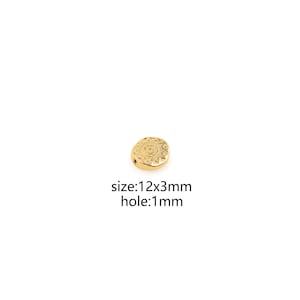 May include: Gold-toned metal bead with a circular, ornate design. The bead measures 12mm x 3mm with a 1mm hole.