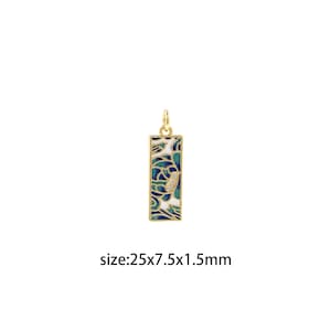 May include: A rectangular pendant with a gold-colored frame and a colorful floral design in shades of blue, green, and white. The pendant has a small loop at the top for a chain. The dimensions are 25mm x 7.5mm x 1.5mm.