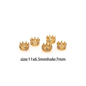 May include: Five gold crown-shaped bead caps with clear rhinestones. The bead caps are 11mm x 6.5mm with a 7mm hole.