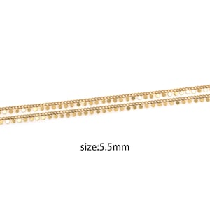 May include: Gold chain with small round charms hanging from it. The chain is 5.5 mm wide.