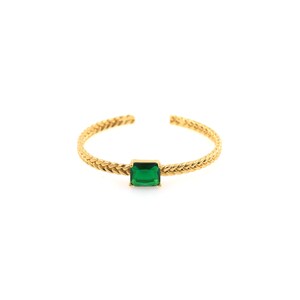 May include: A gold braided bangle bracelet with a square emerald green gemstone.