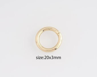 May include: A gold-colored, circular clasp with a hinged opening. The clasp is 20mm in diameter and 3mm thick. The product is shown against a white background. The text "size: 20x3mm" is below the clasp.