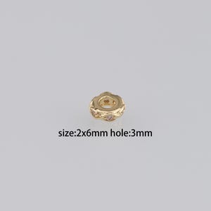May include: Gold-toned spacer bead with clear rhinestones. The bead is 2mm wide and 6mm long with a 3mm hole.