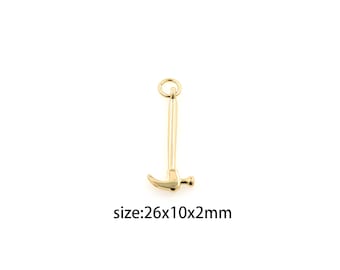 May include: Gold-colored hammer charm with a loop at the top. The charm is approximately 26 mm long, 10 mm wide, and 2 mm thick.  size:26x10x2mm
