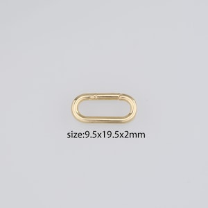 May include: Gold-toned metal oval-shaped clasp with a spring-loaded closure. The clasp measures 9.5 x 19.5 x 2 mm.
