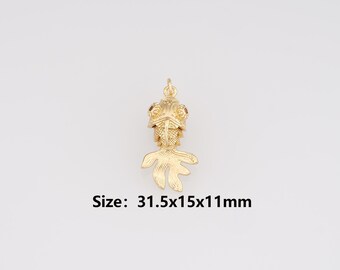 May include: A gold-colored charm in the shape of a goldfish. The charm has a detailed design, including a crown on its head and flowing fins. The text "Size: 31.5x15x11mm" is below the charm.