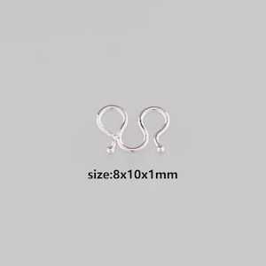 May include: A silver-colored metal clasp with a unique, curved design. The clasp features two rounded loops connected by a curved bar, with small ball accents at the ends. The text "size: 8x10x1mm" is displayed below the clasp.