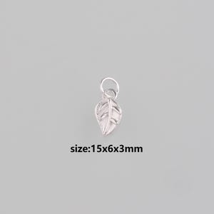 May include: A small, silver-colored leaf charm with a textured surface and a loop for attaching to jewelry. The leaf measures approximately 0.6 x 0.2 x 0.1 inches. The charm is set against a neutral gray background.