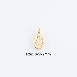 May include: Gold oval charm with a sun design and a small pink rhinestone in the center. The charm measures 18x9x2 mm.