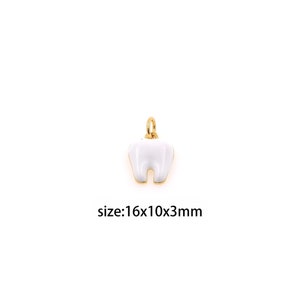 May include: A gold-colored charm in the shape of a white tooth. The charm is 16mm x 10mm x 3mm in size.
