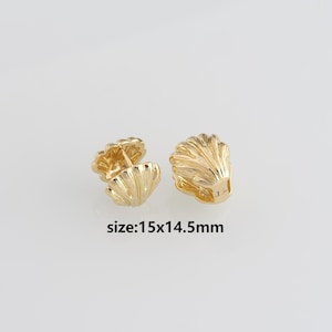 May include: Two gold-colored seashell-shaped earrings. The earrings have a detailed, ridged design and are approximately 0.6 x 0.6 inches in size. The text "size:15x14.5mm" is visible in the image.