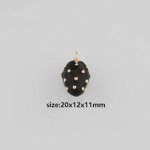 May include: Black pendant with gold-colored accents. The pendant has a rounded shape and is covered in small, evenly spaced gold dots. The text "size:20x12x11mm" is visible below the pendant.