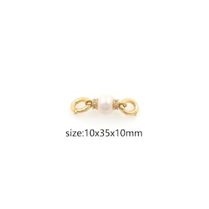 May include: Gold-toned clasp with a white pearl and clear crystal accents. Size: 10x35x10mm.