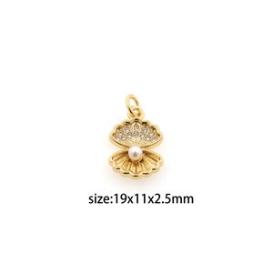 May include: Gold-tone seashell charm with a pearl and clear rhinestones. The charm is 1.9 cm wide, 1.1 cm tall, and 0.25 cm thick. size:19x11x2.5mm
