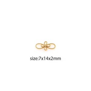 May include: Gold-toned metal connector with a flower design. The connector measures 7mm x 14mm x 2mm.  size:7x14x2mm