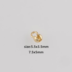 May include: A gold-coloured jewellery clasp with a round shape and a small loop. The text "size: 5.5x3.5mm 7.5x5mm" is printed below the clasp.