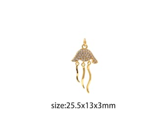 May include: Gold-toned pendant charm shaped like a jellyfish with clear crystal accents. The charm measures 2.5 x 1.3 x 0.3 inches.
