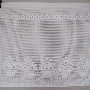 May include: White sheer valance with a delicate floral pattern. The valance features a repeating design of three flower pots with flowers.
