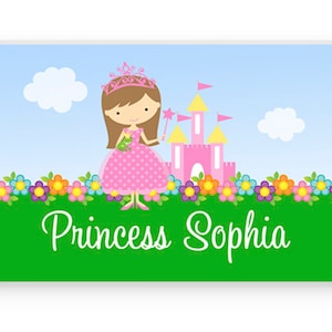 May include: A pink castle with a princess in a pink dress and a crown standing in front of it. The princess is holding a wand. There are flowers and green grass in the background. The text "Princess Sophia" is written below the image.
