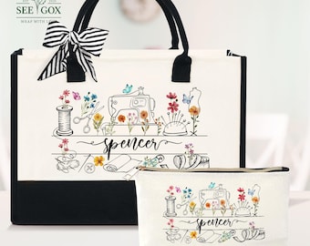 May include: A white tote bag and matching cosmetic bag with black accents. Both bags feature a sewing-themed design with a sewing machine, flowers, and the name "Spencer". A black and white striped bow adorns the tote bag.