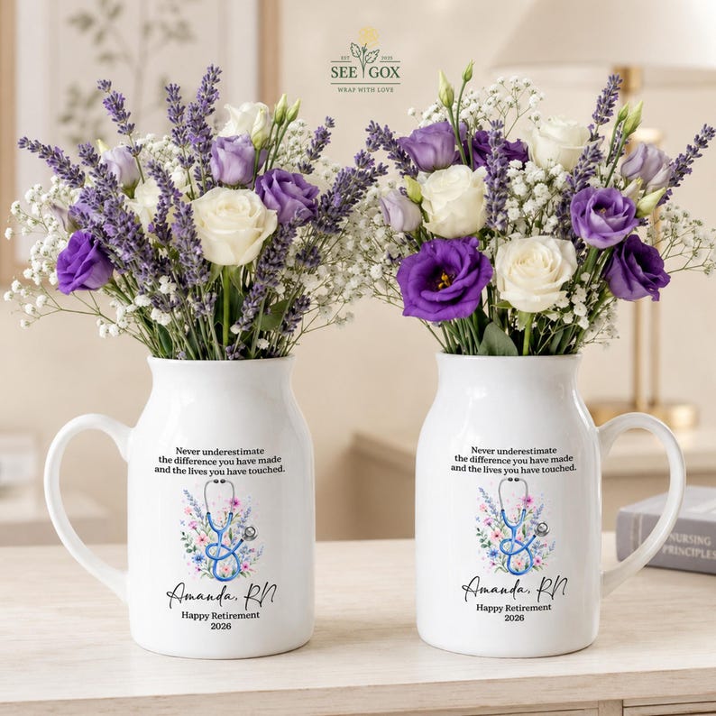 May include: Two white ceramic pitchers filled with lavender, white roses, and baby's breath. Each pitcher features a stethoscope graphic, floral accents, and the text: Never underestimate the difference you have made and the lives you have touched. Amanda, RN. Happy Retirement 2026.