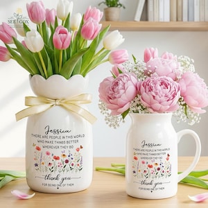 May include: A white ceramic vase and a matching white ceramic mug, both featuring a floral print, the name Jessica, and the text: There are people in this world who make things better wherever they go, thank you for being one of them.