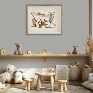 May include: A framed illustration with a boy, bear, and tiger, with the text "THEODORE!" on a banner. The room features wooden shelves with toy houses, soft toys, and a small table with stools, creating a cosy children's room setting.