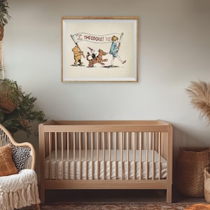 May include: A framed illustration featuring Winnie the Pooh, Tigger, and Christopher Robin. The characters are marching with a banner that reads "Theodore!" The artwork is displayed above a wooden cot in a nursery setting.