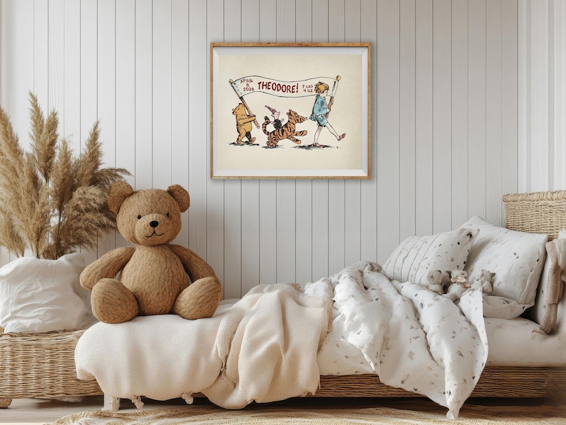 May include: A framed vintage illustration with a bear, tiger, and boy, with the text "THEODORE!". The artwork hangs above a bed with a teddy bear and neutral-toned bedding. The room has a cozy, inviting atmosphere.