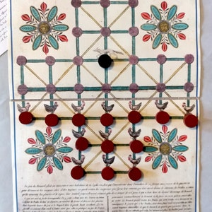 May include: An antique board game, "Le plaisant et récréatif Jeu du Renard," featuring a grid design with red game pieces and a black piece. The game board has floral and animal illustrations, with text in French.
